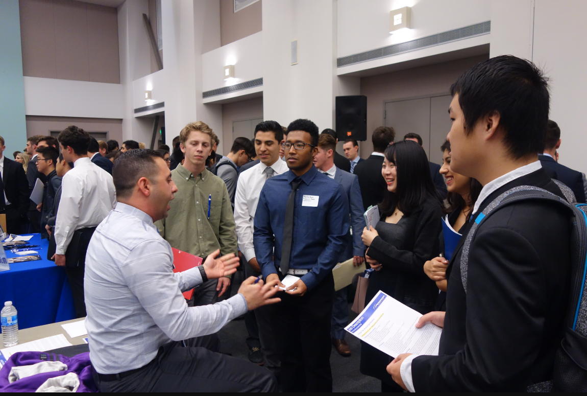 Employer and students talking at a career fair